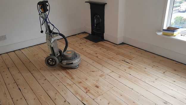 hardwood floor refinishing in progress